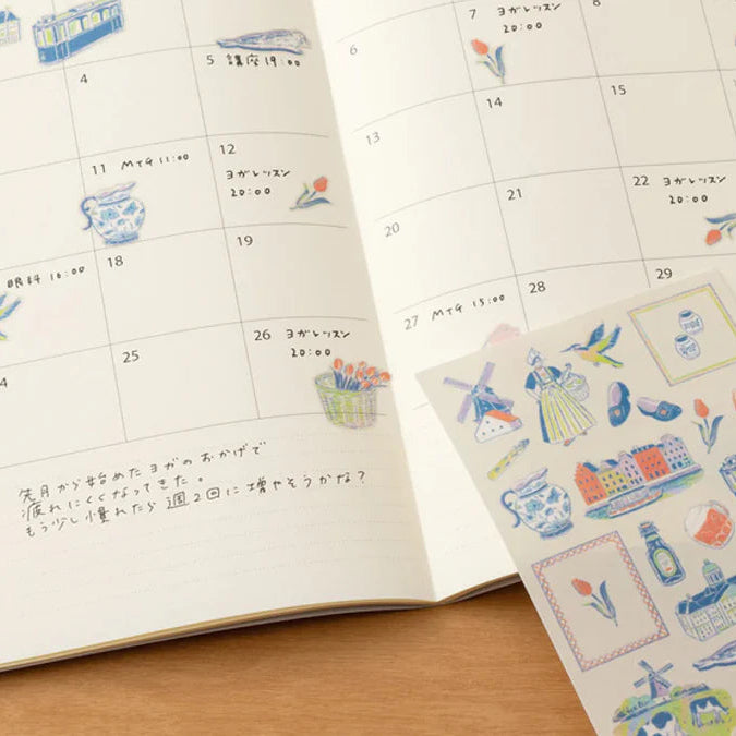 Calendar with decorative stickers on a wooden surface