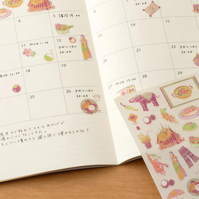 Calendar with decorative stickers on a wooden surface